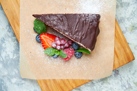 Chocolate cake. Gray textured background. Beautiful serving dishes. Dessert. Food chain
