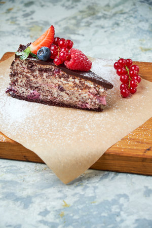 Cherry berry cake. Gray textured background. Beautiful serving dishes. Dessert. Food chain