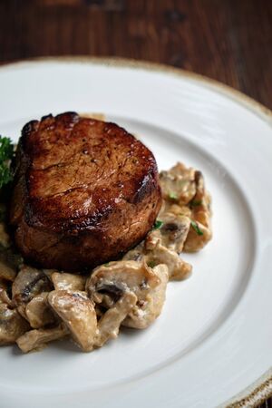 Meat medallion with mushrooms. restaurant menuの写真素材
