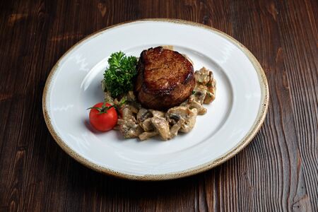 Meat medallion with mushrooms. restaurant menuの写真素材