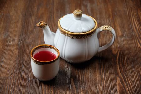 Different tea in teapots on a dark wooden background. catering menuの写真素材