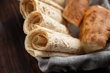 Pita bread of different types in a bread basket . restaurant menu