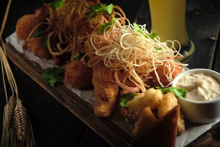 Glass of cold beer with appetizer. catering menuの写真素材