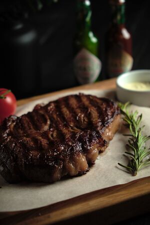 Meat steak on a wooden board. catering menuの写真素材