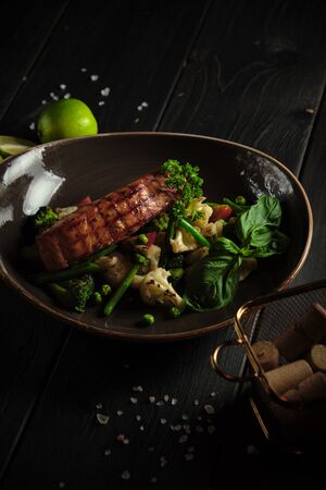 Grilled fish steak with broccoli and cauliflower. catering menuの写真素材