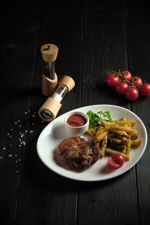 Meat medallion and french fries . catering menuの写真素材