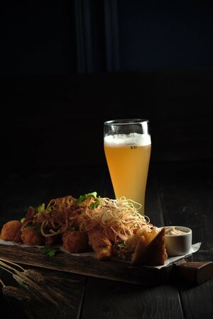 Glass of cold beer with appetizer. catering menuの写真素材