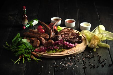 Meat on the bone on a wooden board . catering menuの写真素材