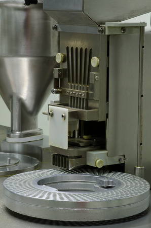 Semi-Automatic capsules filling in the plant has received GMP  PICs Pharmaceutical Inspection Co-operation Schemeの写真素材