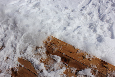 Melted snow on a wooden board.の写真素材