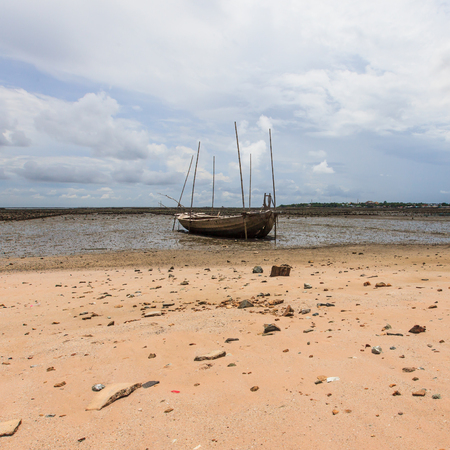 Fisherman boat on sand mudの写真素材
