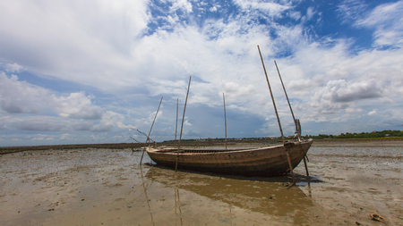 Fisherman boat on sand mudの写真素材