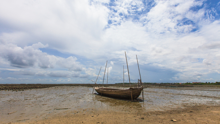 Fisherman boat on sand mudの写真素材