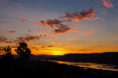 Silhouette sunrise and golden sky with riverの写真素材