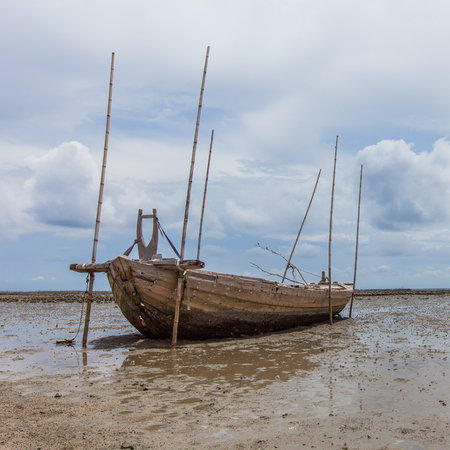 Fisherman boat on sand mudの写真素材