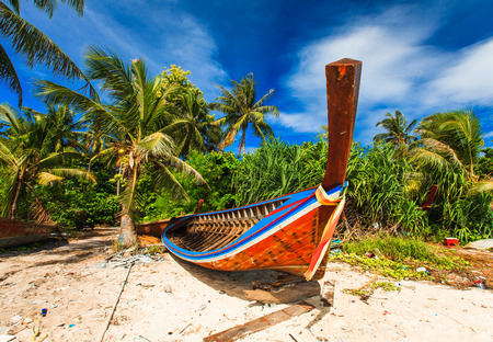 Fisherman boat on beach and blue skyの写真素材