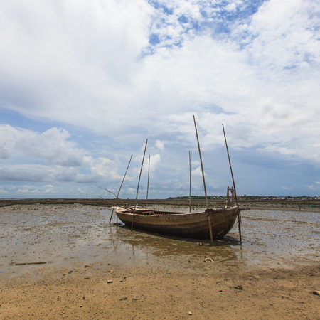 Fisherman boat on sand mudの写真素材