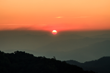 Beautiful sunrise sky and silhouette pine tree on top of mountainの写真素材