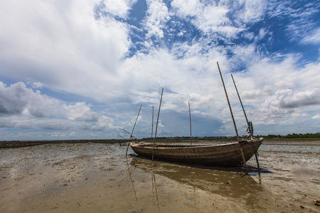 Fisherman boat on sand mudの写真素材