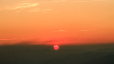 Beautiful sunrise sky and silhouette pine tree on top of mountainの写真素材