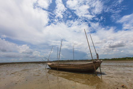 Fisherman boat on sand mudの写真素材