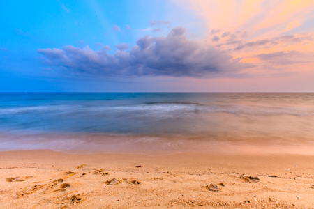 Beautiful sunrise sky over tropical beach and seaの写真素材