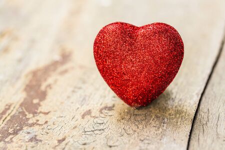 Red valentine heart on grunge wooden backgroundの写真素材