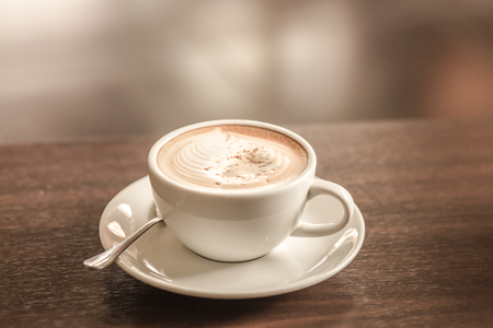 Hot cappuccino on table in cafe. vintage filterの写真素材