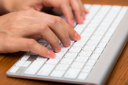 hand using computer doing work at homeの写真素材