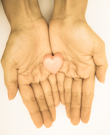 Hand hold heart on white backgroundの写真素材