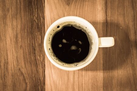 Top view hot coffee on wooden backgroundの写真素材
