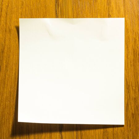 Blank note stick on wooden wallの写真素材