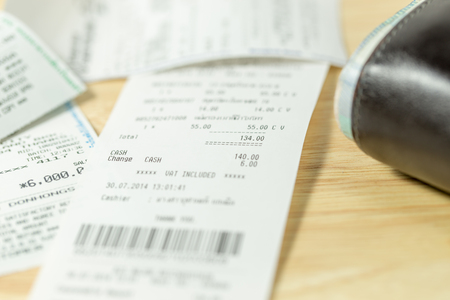 Grocery bill and wallet on wood backgroundの写真素材