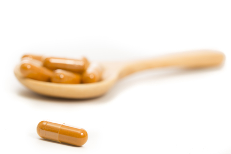 Medical herb capsule on white backgroundの写真素材