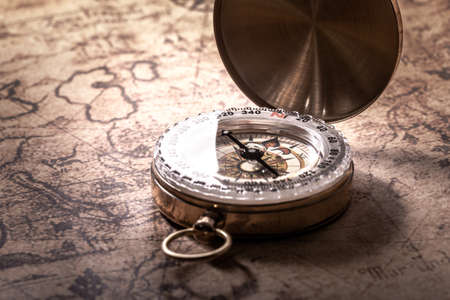 Vintage compass on ancient map close upの写真素材
