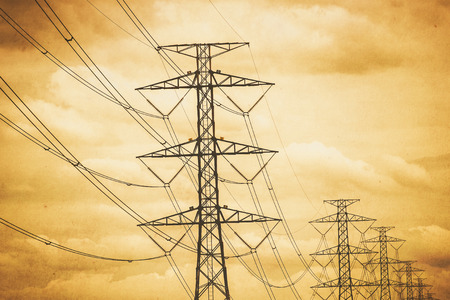 Silhouette high voltage electrical post or tower. vintage filterの写真素材