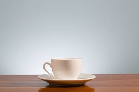 White cup of coffee on wooden tableの写真素材