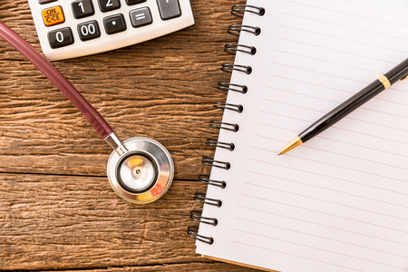 Stethoscope on table with notebookの写真素材