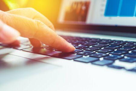 Hand using laptop computer programming coding and doing business onlineの写真素材