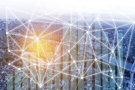 Business network connection and trading graph on city backgroundの写真素材