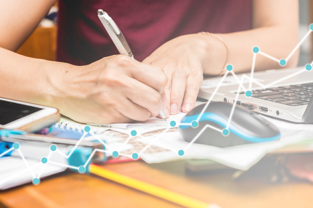 women Working at home with trading graphの写真素材