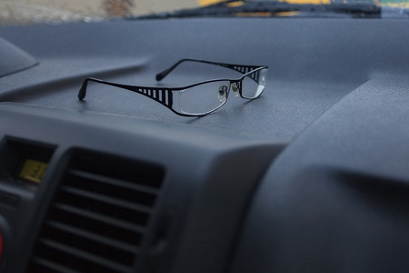 glasses on the dashboard of the carの写真素材