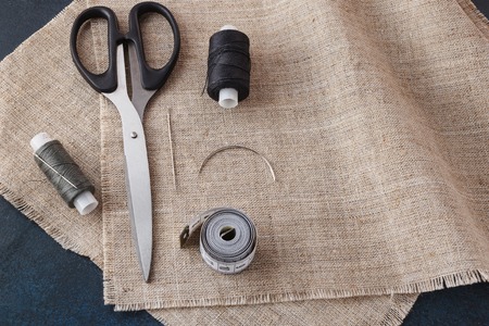 Sewing accessories on a background of canvas fabric.の写真素材