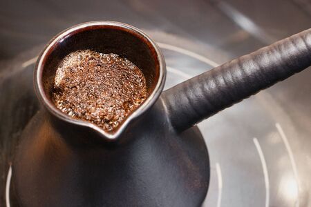 Karamic Turk with coffee on an electric stoveの写真素材