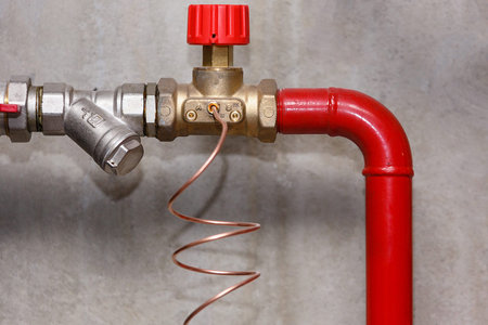 Water supply system node on the background of a concrete wall, close-up