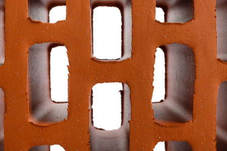 Red brick on a white background, isolated, fragment.