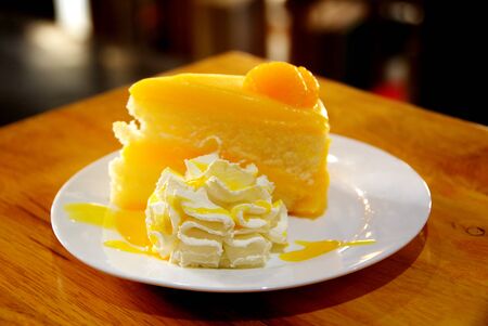 orange cake with whipped creamの写真素材