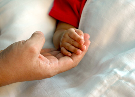 warmly touch, mom's hand with baby's handの写真素材