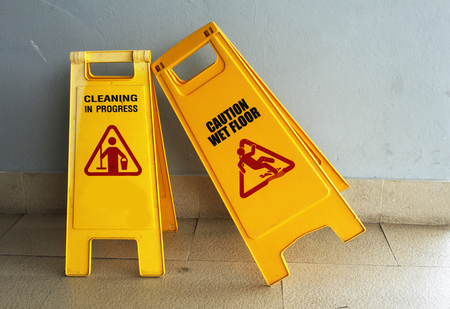 caution wet floor and cleaning in progressの写真素材