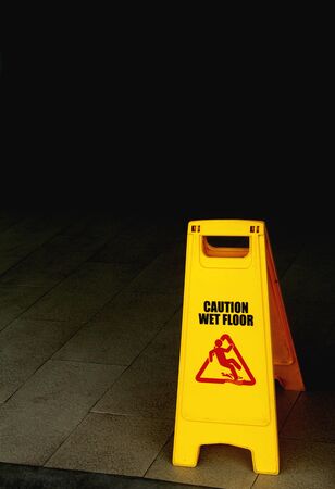 caution wet floor and cleaning in progressの写真素材